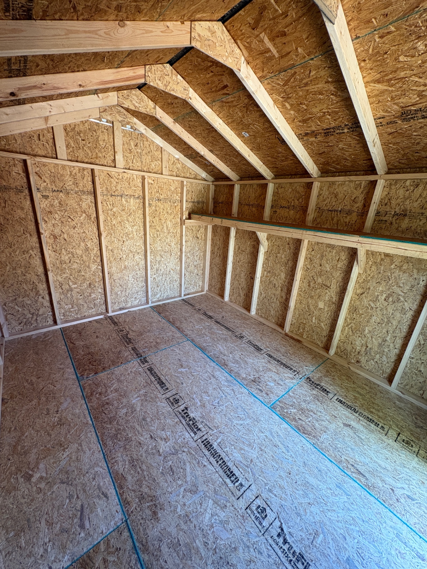 3/4-inch TruFloor tongue-and-groove floor panels inside a Southern Shed Co. build, with the TruFloor stamp visible on each panel